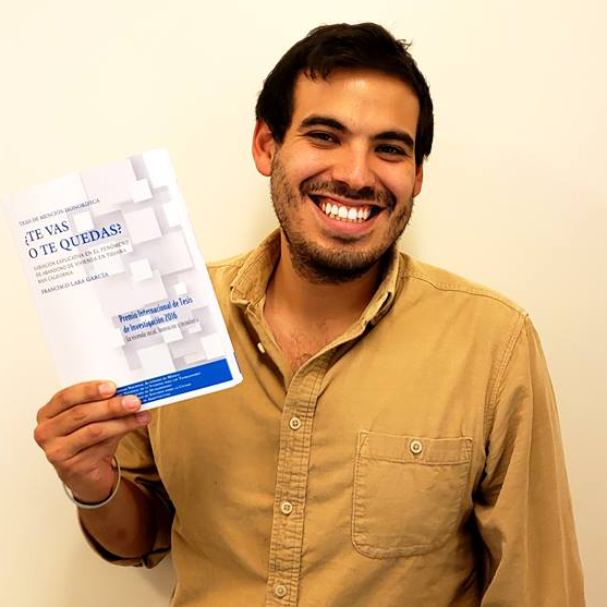 Photo of our PhD Student along side his published book. 